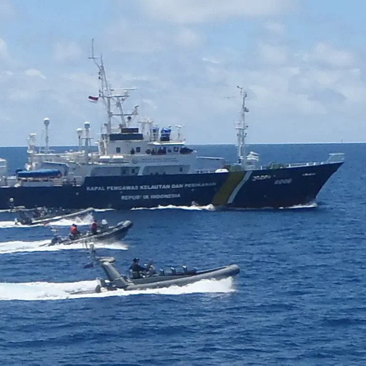 Indonesian maritime patrol ship at sea accompanied by several fast patrol boats, conducting a joint operation with Australia